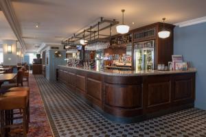 a bar in a restaurant with a counter at Thomas Ingoldsby Wetherspoon in Canterbury