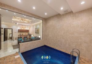 a swimming pool in a living room with a house at فلل تري سيزون in Khamis Mushayt