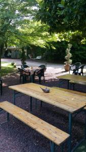 a picnic table and benches in a park at romagnoli family cottage in Ameno