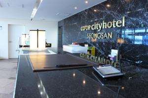 a room with a black counter with a cell phone on it at Co-op City Hotel Seongsan in Seogwipo