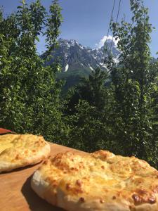 two slices of bread on a table with a mountain at Guest House Murkvam in Tvebishi