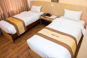 Una cama o camas en una habitación de Hotel Lapha