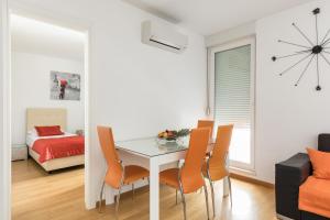 a dining room with a table and chairs and a bedroom at Apartment Marcela With Private Parking in Split