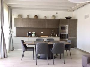 a kitchen with a dining room table and chairs at Sky Fort Garda View in Sirmione