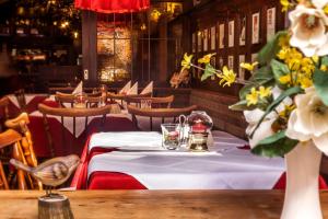 a dining room with a table with flowers on it at Gasthaus Löwen in Freiburg im Breisgau +22 photos