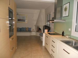 a kitchen with a fireplace in the middle of a room at Villa Kampos Paros in Pounda +34 photos