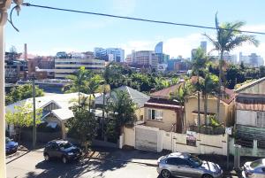 a view of a city with cars parked in front of houses at 4 bedroom house - Walk to Southbank in Brisbane