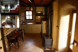 a kitchen with a stove and a table with chairs at cool la source in Burdignes