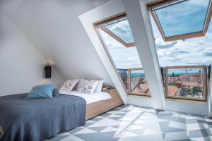 a bedroom with a bed and a large window at Stella Sky in Ljubljana