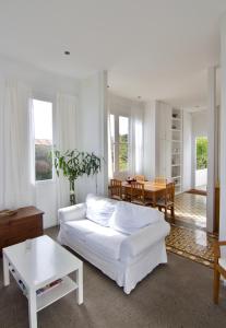 a living room with a white couch and a table at Casa La Breña in Breña Baja