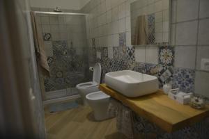 a bathroom with a sink and a toilet at B&b A casa della nonna in Paestum +30 photos