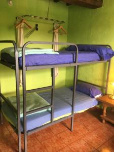 a couple of bunk beds in a room at Albergue Gándara in Santillana del Mar