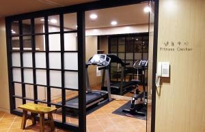 a fitness center with two tread machines in a room at Sendale Zhubei Business Hotel in Zhubei