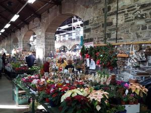 a group of people in a market with flowers at Brentor Self-catering in Brentor