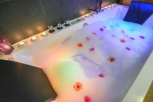 a bath tub filled with snow and flowers at Casa Rural Aguas Frias II in La Omañuela +48 photos