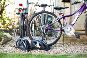 a bike parked next to two helmets on the ground at Gwithian Holidays in Hayle