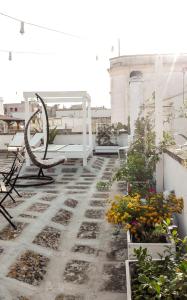 a patio with flowers and a bench on a roof at Il Borgo in Poggiardo