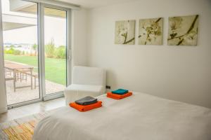 a bedroom with a bed and a chair and a window at Palmares Beach, Golf & Dream in Lagos