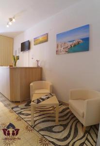 a waiting room with two chairs and a reception desk at Le Bouganville in Vieste +23 photos