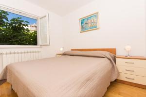 Ein Bett oder Betten in einem Zimmer der Unterkunft Apartments Vukman