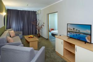 a living room with a flat screen tv in a room at Hotel Aktinia - All Inclusive in Sunny Beach