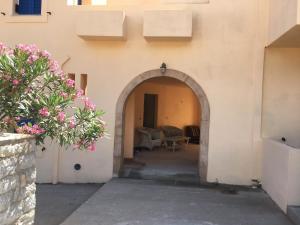 an entrance to a building with an archway at Eugenia travasarou sea view appartments in Diakofti