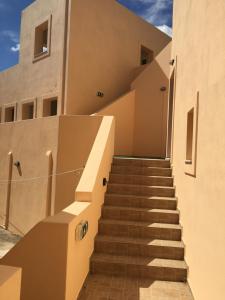 a set of stairs leading up to a building at Eugenia travasarou sea view appartments in Diakofti