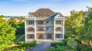 an aerial view of a large white house at Hotel Villa Halliger in Göhren