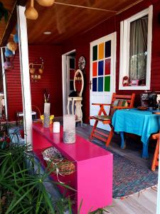 a red house with a table and a blue table at Side Tuana Garden Home in Side