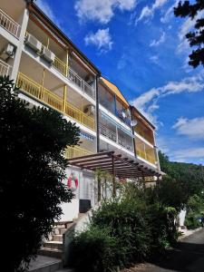 a building with balconies on the side of it at Apartments Alyssa in Ičići