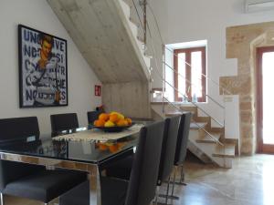 a dining room table with chairs and a bowl of oranges on it at Esglesia 10 in Alcudia