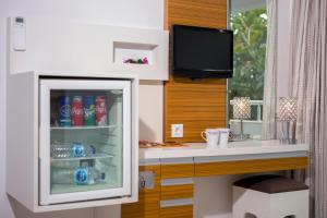 a kitchen with a refrigerator with drinks in it at Hotel Delta in Fethiye