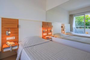 Postel nebo postele na pokoji v ubytování Hotel Delta