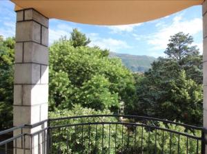 a balcony with a view of trees and mountains at Apartment Ema in Trebinje