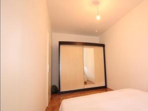 a bedroom with a large mirror on the wall at Apartment Ema in Trebinje