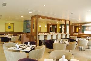 a restaurant with tables and chairs in a room at Daspalla Hyderabad in Hyderabad