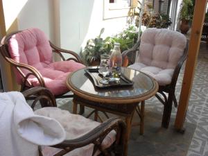 a table with two glasses and two chairs at La Santre Villa in Amoudara Herakliou