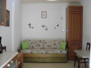 a bedroom with a bed with green pillows at La Santre Villa in Amoudara Herakliou