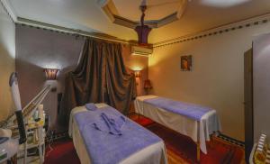 a hospital room with two beds and a window at Hotel Islane in Marrakech