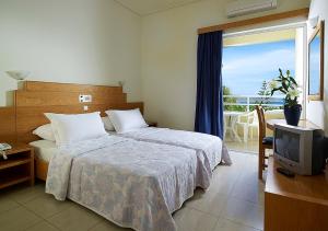 Postel nebo postele na pokoji v ubytování Eleftheria Hotel