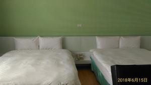 A bed or beds in a room at SKY square Homestay