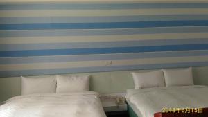 A bed or beds in a room at SKY square Homestay