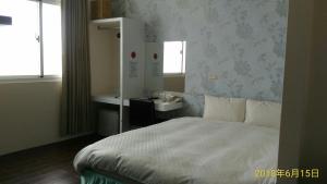 A bed or beds in a room at SKY square Homestay