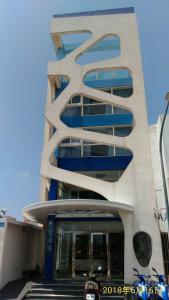 un edificio alto con azul y blanco en SKY square Homestay, en Magong