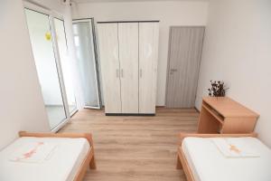 a small room with two beds and a desk at Apartment Ćukušić in Split