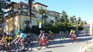 a group of people riding bikes down a street at Tivoli Apartment in Ičići