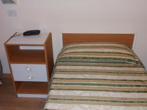 Postel nebo postele na pokoji v ubytování Hotel Cecco