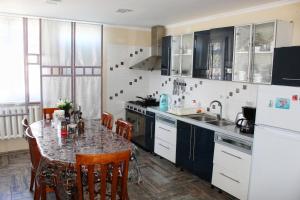 a kitchen with a table and a counter top at Tian-Shan Guest House in Balykchy