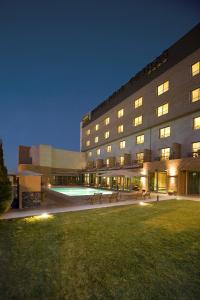 a large building with a lawn in front of it at Hotel Real Oeiras in Oeiras