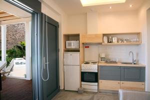 a kitchen with a sink and a stove top oven at Artemis Village Apartments & Studios in Stavros